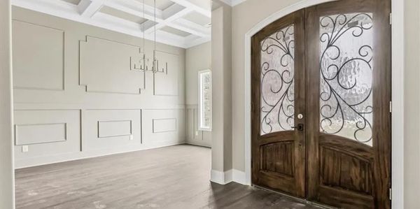 Ornate wooden double doors with ironwork.