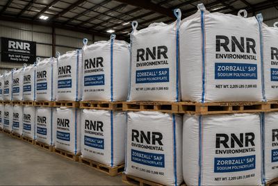 Stacked RNR Environmental Zorbzall SAP bags in a warehouse.