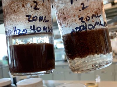 Industrial wastewater heavy metal removal jar test showing treated water and separated solids