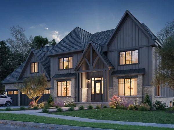 Elegant modern house with warm interior lighting at dusk.