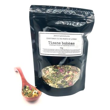 Black pouch of Tisane bohème herbal tea with loose leaves and wooden spoon.