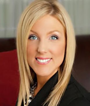 Smiling woman with blonde hair in a professional setting.