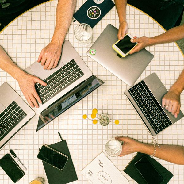 Top view of a team collaborating to work on marketing strategies for graphic design projects