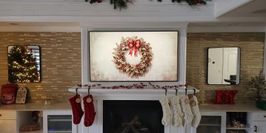 Cozy Christmas fireplace with stockings and decorations.