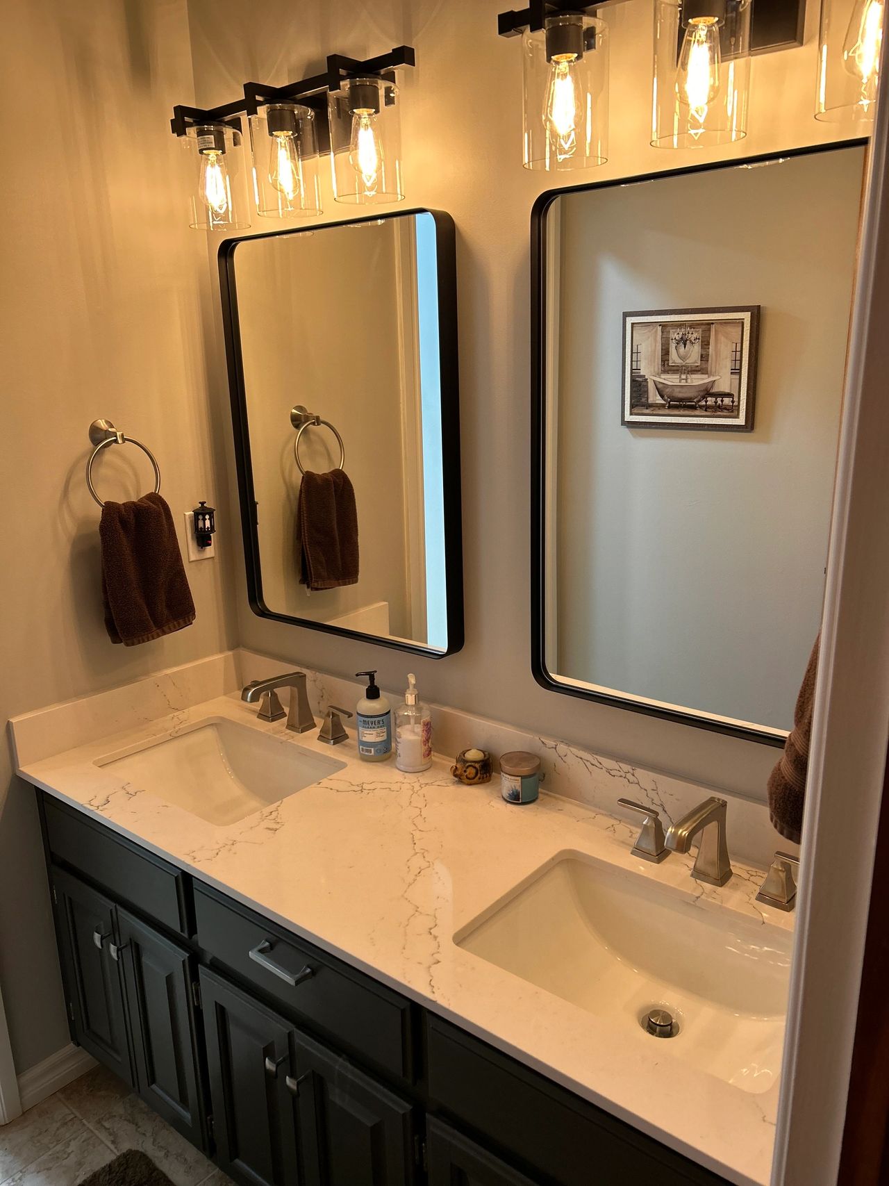 This shows the Cambria Colton Quartz countertops as well as the framed mirrors and separate light fixtures.