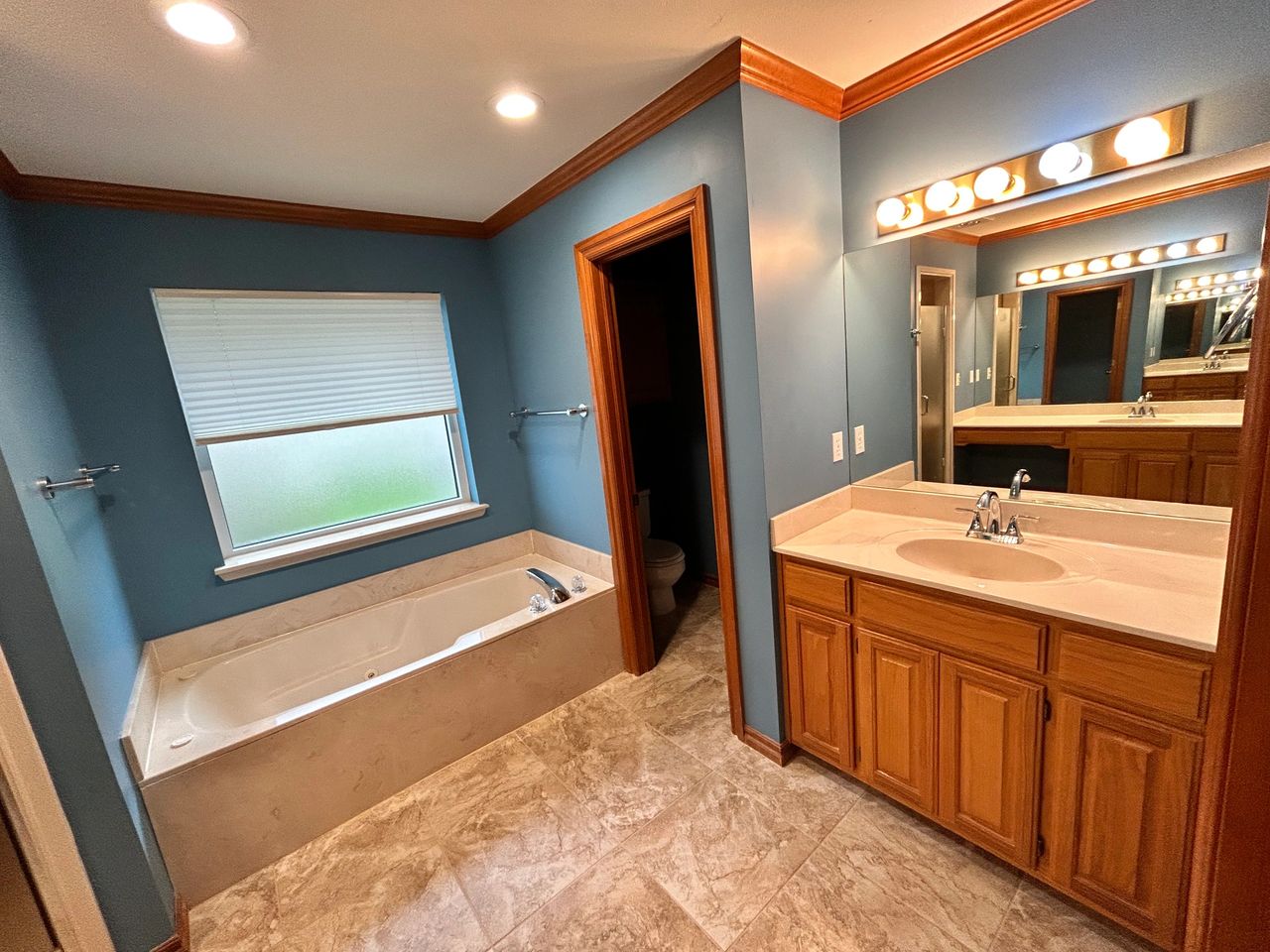 His side of the bathroom and the tub they no longer use.