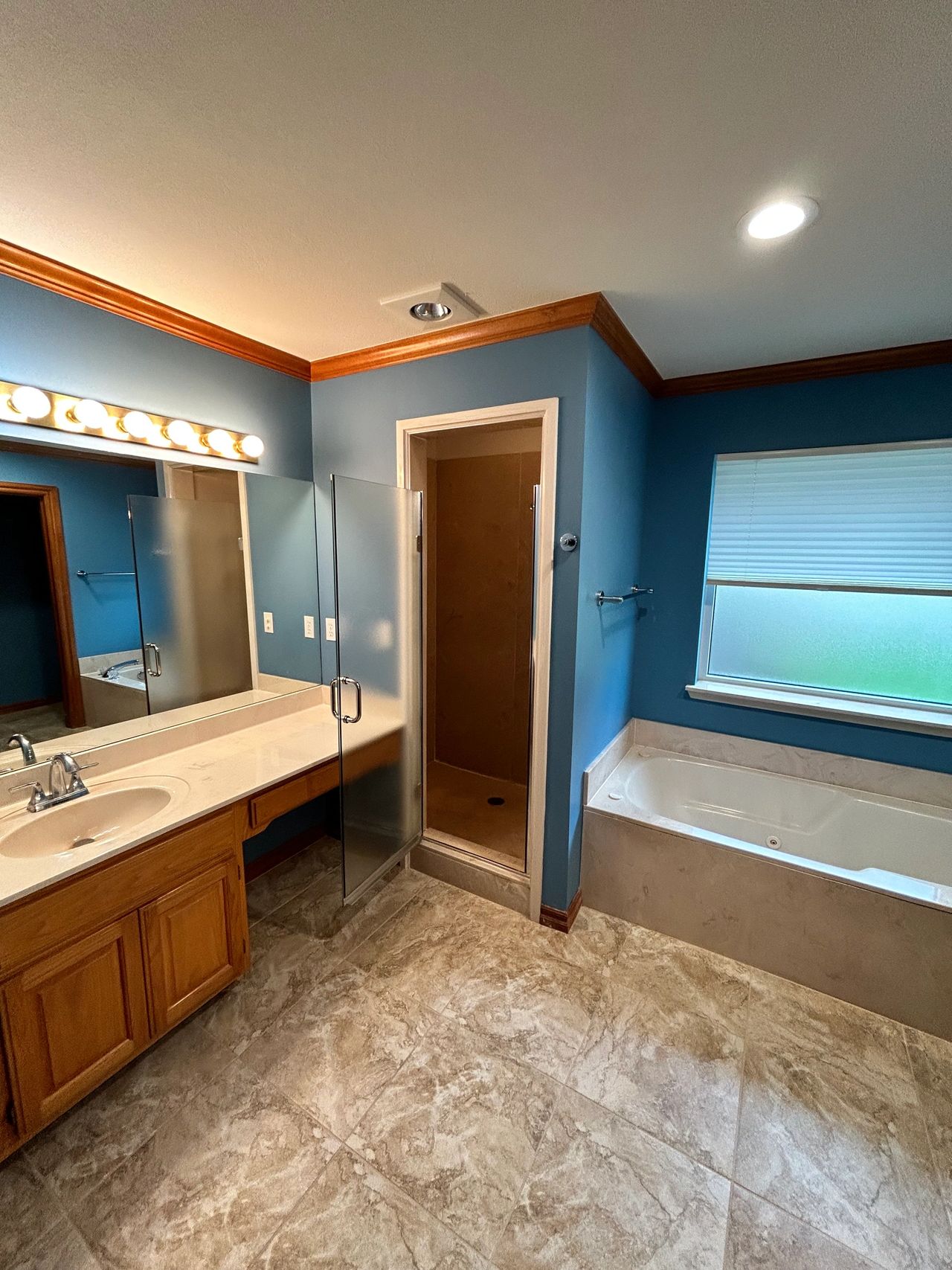 More of the shower and her vanity with the knee drawer.