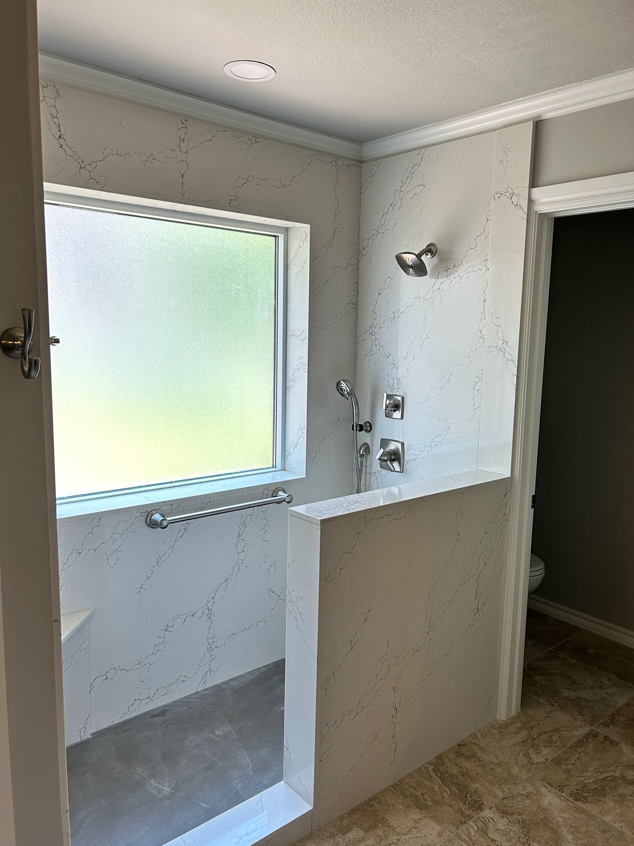 New Cambria quartz shower with Colton on the walls and a matte gray for the floor.