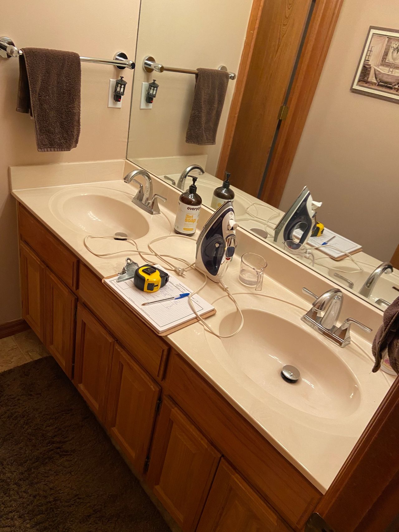 Here are the original stained cabinets with cultured marble countertops.  This also shows the large builder grade mirror.