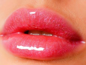 Glossy pink lips with a smooth shine close-up.