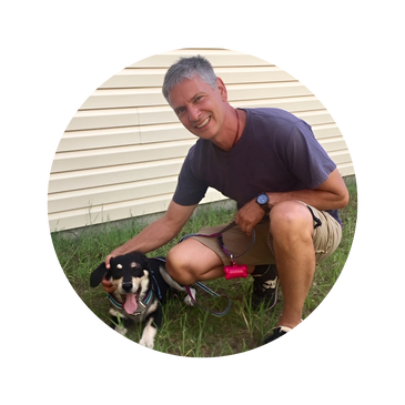 Morganton dog walker and pet sitter John Barrile scratches a dog's ears after a nice long walk.