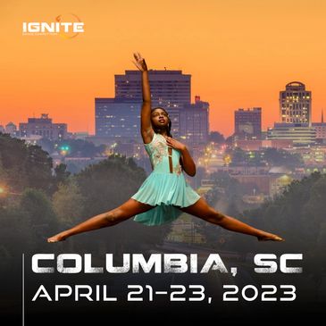 Dancer in a lyrical costume in front of a photo of Columbia, South Carolina