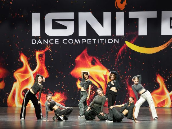 Dancers posing on stage at IGNITE dance competition.