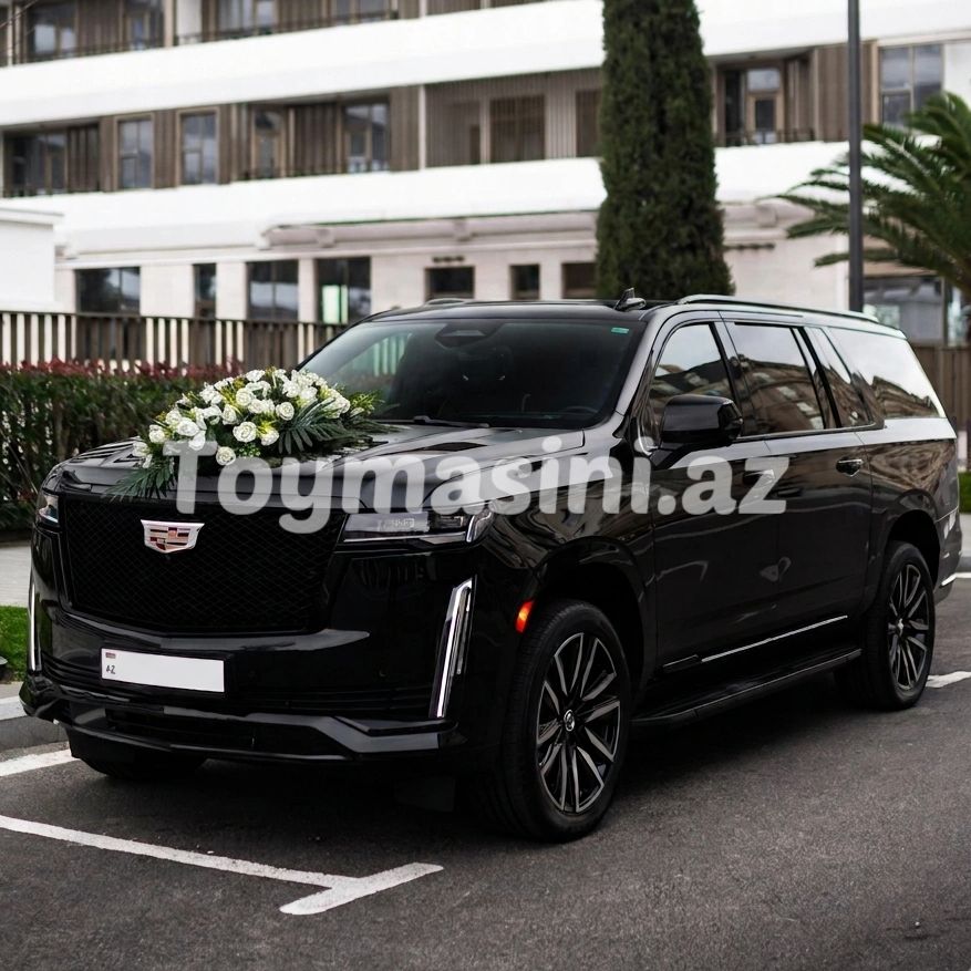 A black luxury SUV decorated with white flowers on the hood.