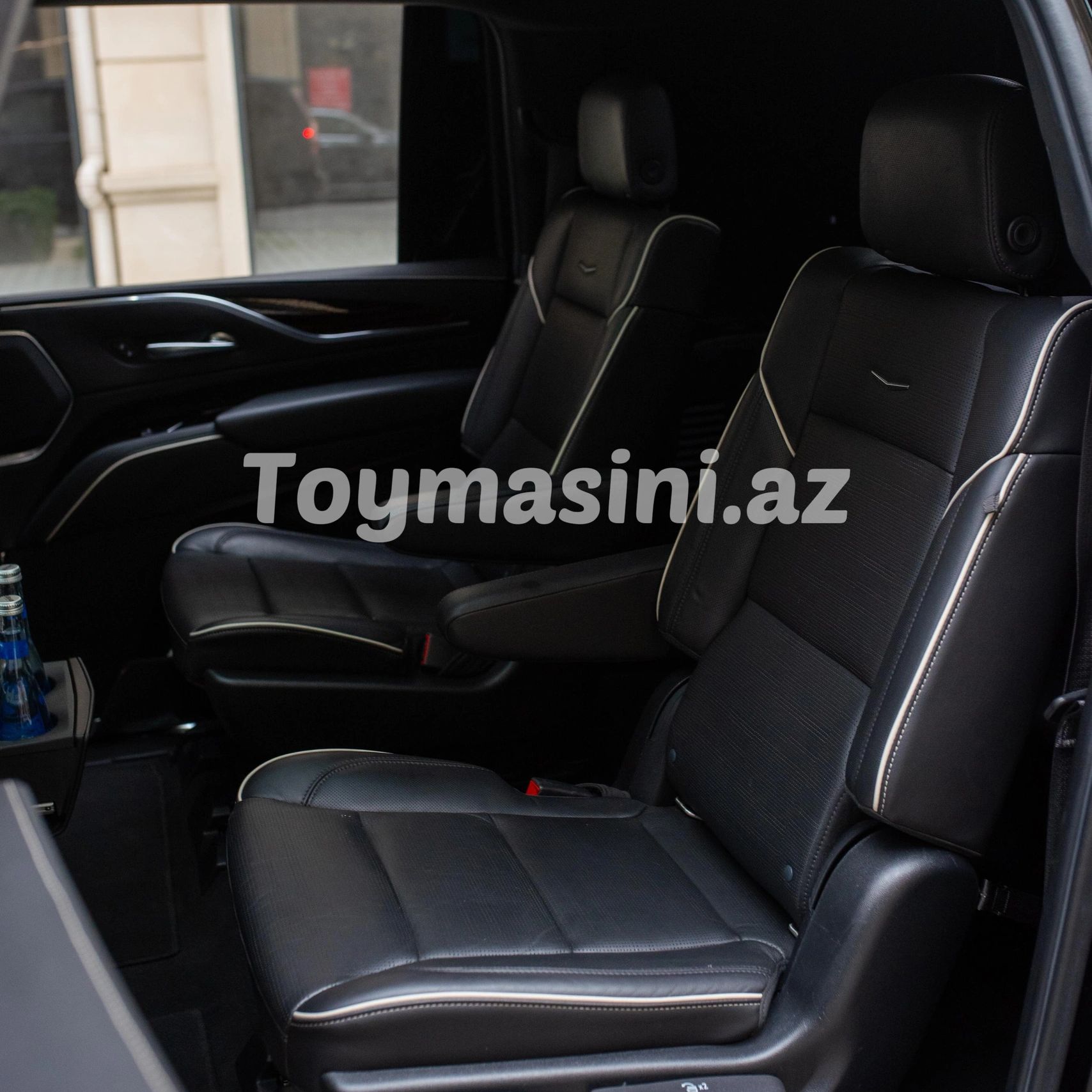 Luxurious black leather car seats with white piping detail.