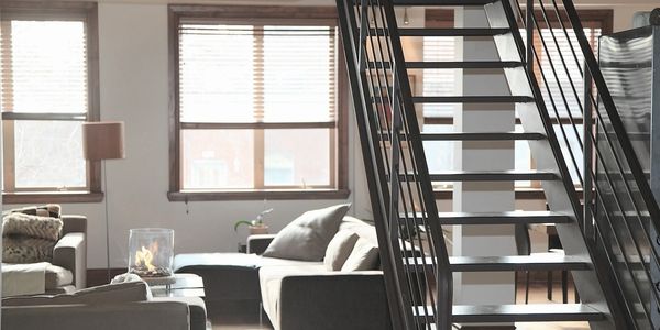 A staircase in a home being analyzed to prepare a sketch of the square footage measurement.