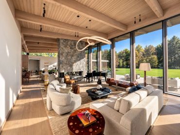 Spacious living room with large windows and modern furniture.