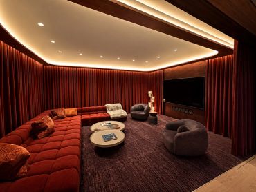 Luxurious home theater room with plush seating and ambient lighting.