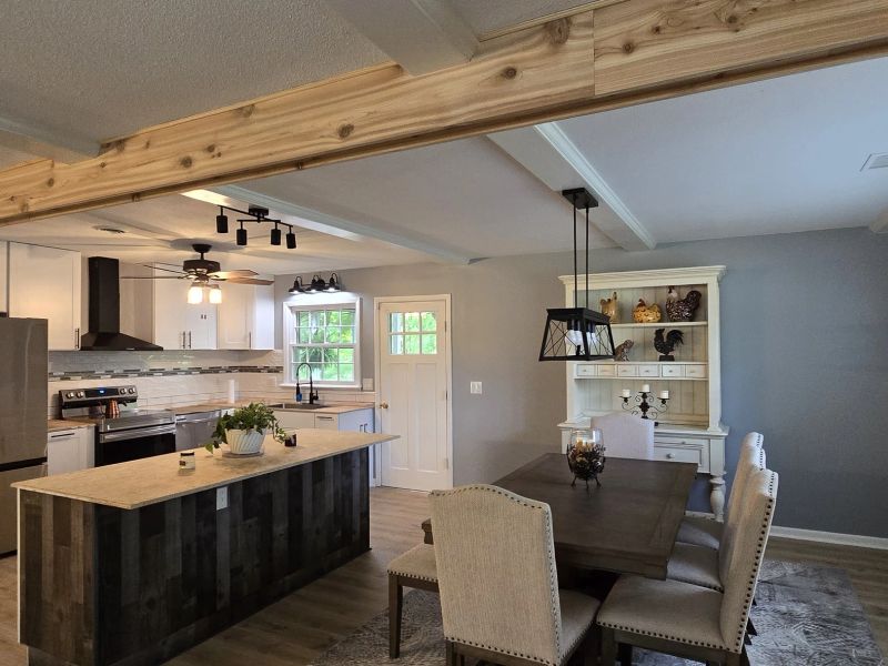 Finished kitchen and dining room with exposed cedar beam