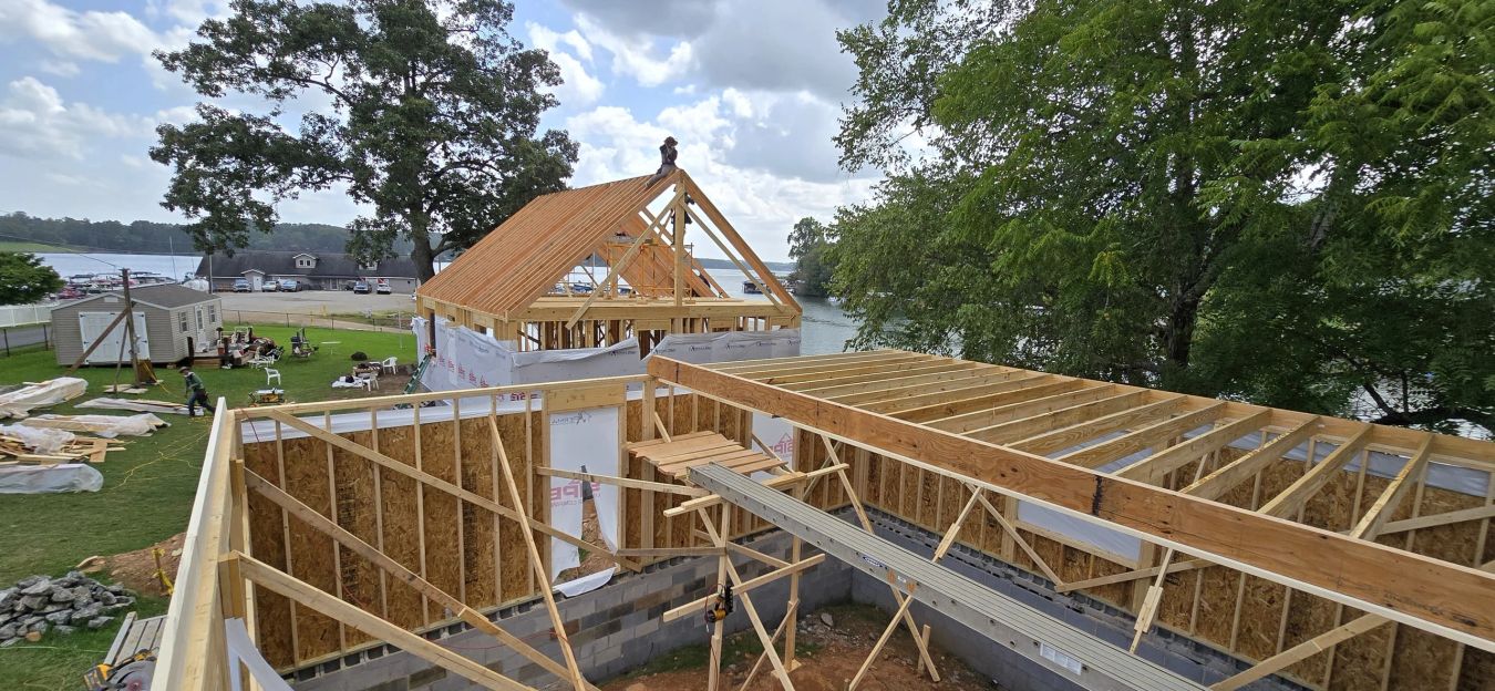 Floor system framed over a block foundation at dusk, autumn ridgeline behind