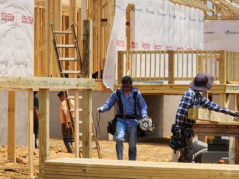 Crew working on wall framing and sheathing