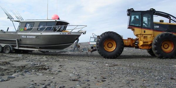 Tractor pulling boat from water