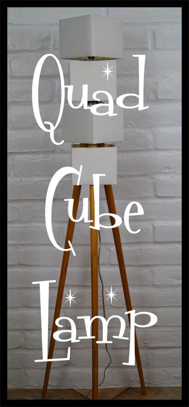 A quad cube floor lamp with wooden tripod legs.