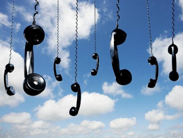 Phone handsets hanging from the sky