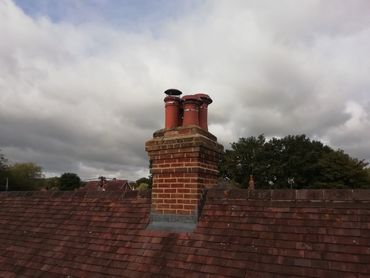 A clutch of Chimney Pots all with new Cowls fitted in Liss to help avoid unwelcome visitors 