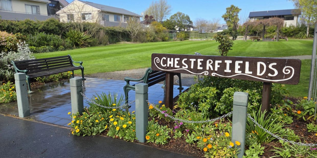 Park entrance with Chesterfields sign and benches.