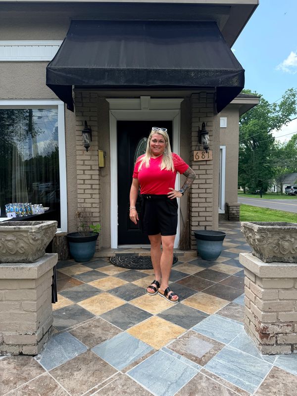 Tekila Midkiff, Paducah Realtor, standing in front of a home. 