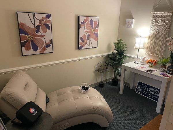 Cozy relaxation corner with chaise lounge and calming decor.