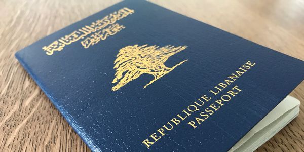 Close-up of a Lebanese passport on a wooden surface.