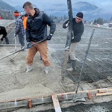 Brown Bear Masonry employees pouring out concrete on a large commercial slab in Grants Pass, Oregon