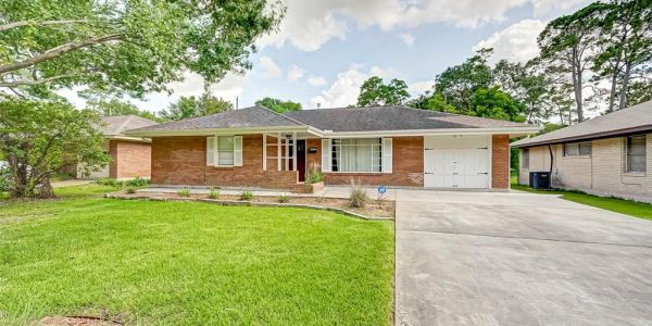 Single-story brick house with a well-kept front lawn.