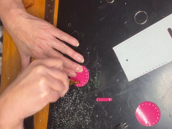 Here I am working on a pink hand-stamped cutouts that will be the gussets to a new doggy-poo bag holder.