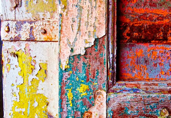 Old door panel with many layers of paint adding texture to the image