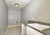 Large Utility Room featuring Cabinetry & Sink