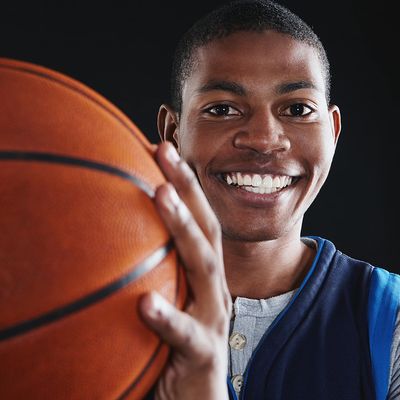 Happy young man, playing basketball