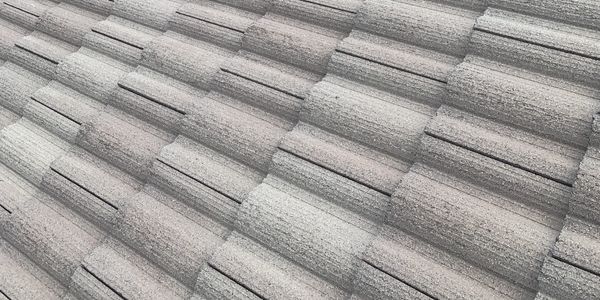 Close-up of a textured gray roof with overlapping tiles.