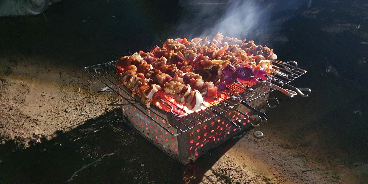 Easy bbq - homemade kebabs over charcoal on an old drip tray... 