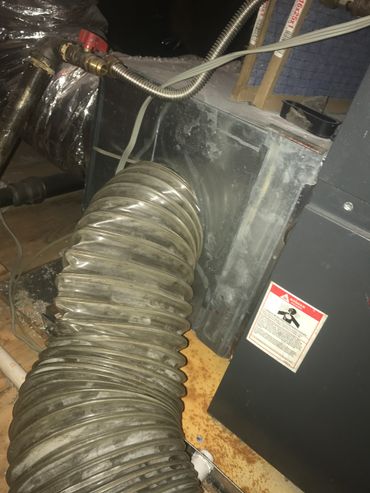 Main duct hose connected to hvac system cleaning the air ducts