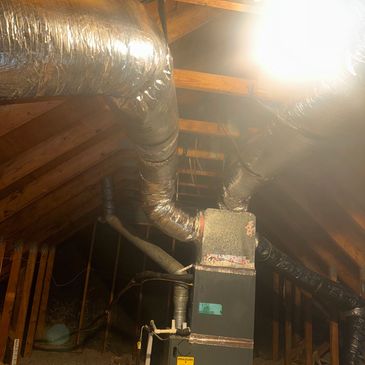View of attic HVAC system with ductwork.