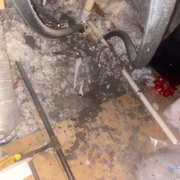 Water leakage causing floor damage under insulation and pipes.