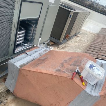Maintenance tools on a rooftop air conditioning unit.