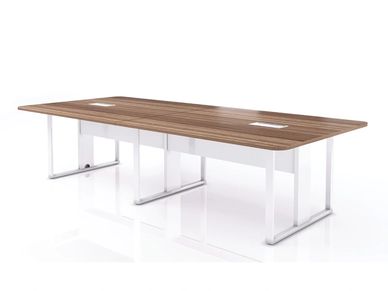 A two-legged rectangular conference table. Office meeting space with chairs and a laptop.