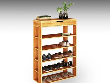 A collection of shoes organized on an open wooden shoe rack.