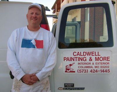 Picture of Keith Caldwell standing next to his van with his logo on the door