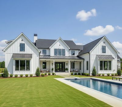 Large modern farmhouse with a swimming pool and manicured lawn.