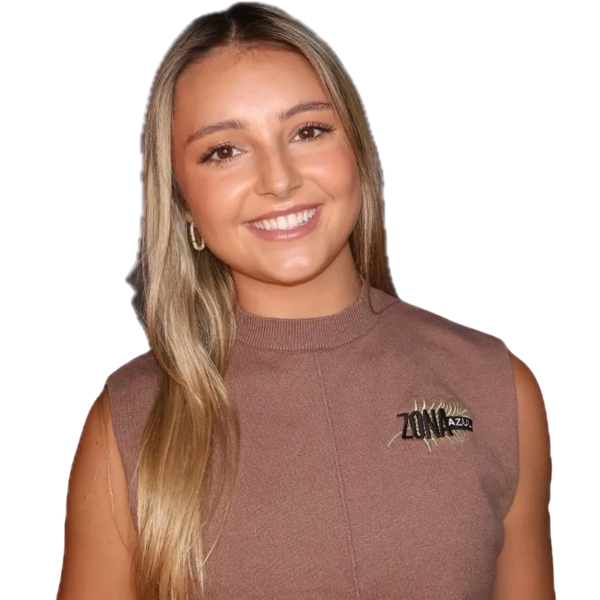 Smiling young woman with long blonde hair wearing a sleeveless brown top. Marketing manager 